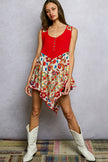 Red ribbed tank top with colorful floral woven print patch and asymmetrical hem.