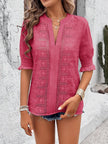 white eyelet blouse displayed on a hanger showing soft flounce sleeves