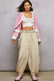 Pink cardigan showcasing contrast border and buttoned front