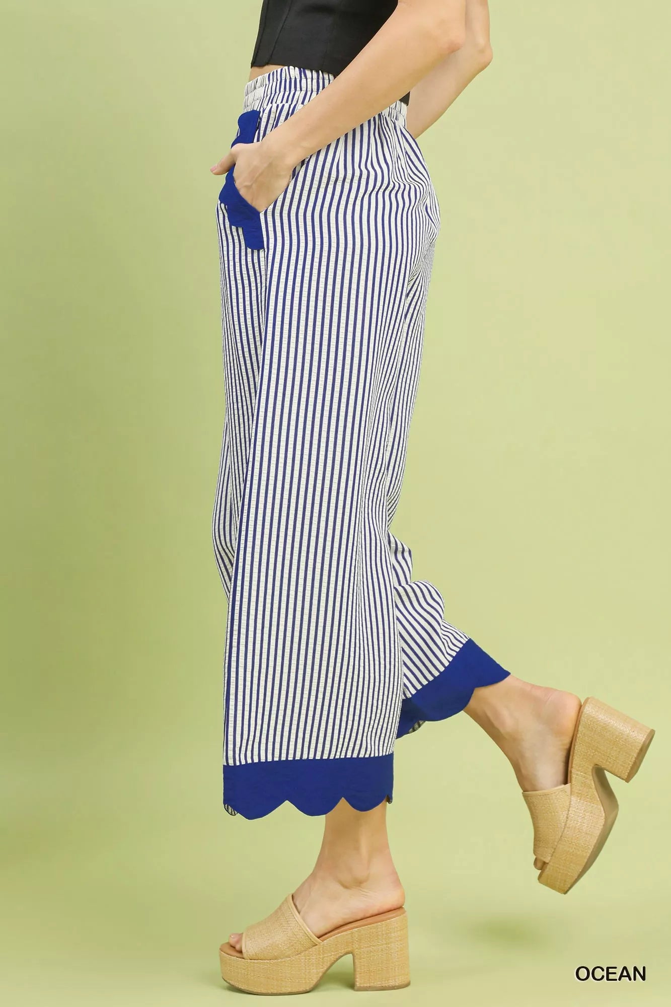 Close-up of scalloped hem detail on wide-leg pants