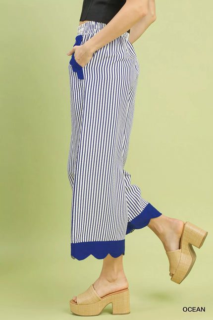 Close-up of scalloped hem detail on wide-leg pants
