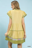 Lime green linen tiered dress with floral trim and flutter sleeves
