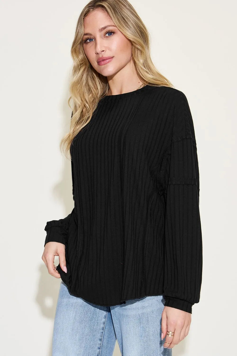 Model wearing ribbed long sleeve tshirt with fitted bust area
