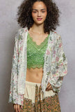 Close-up of boho floral fringe detail on cardigan