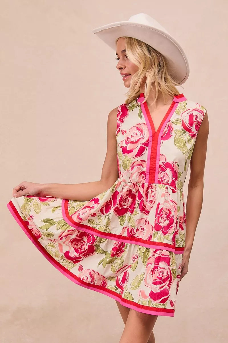 Coral pink floral tiered ruffle mini dress with rose pattern and red trim