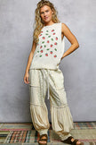 Cream knit sweater top with red strawberry pattern and green leaves, sleeveless round neck design.