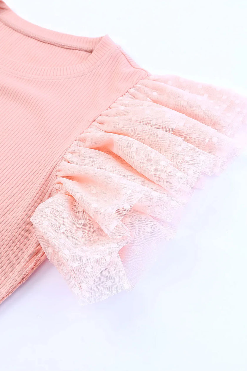 Pink ribbed blouse with polka dot ruffled cap sleeves and soft texture.