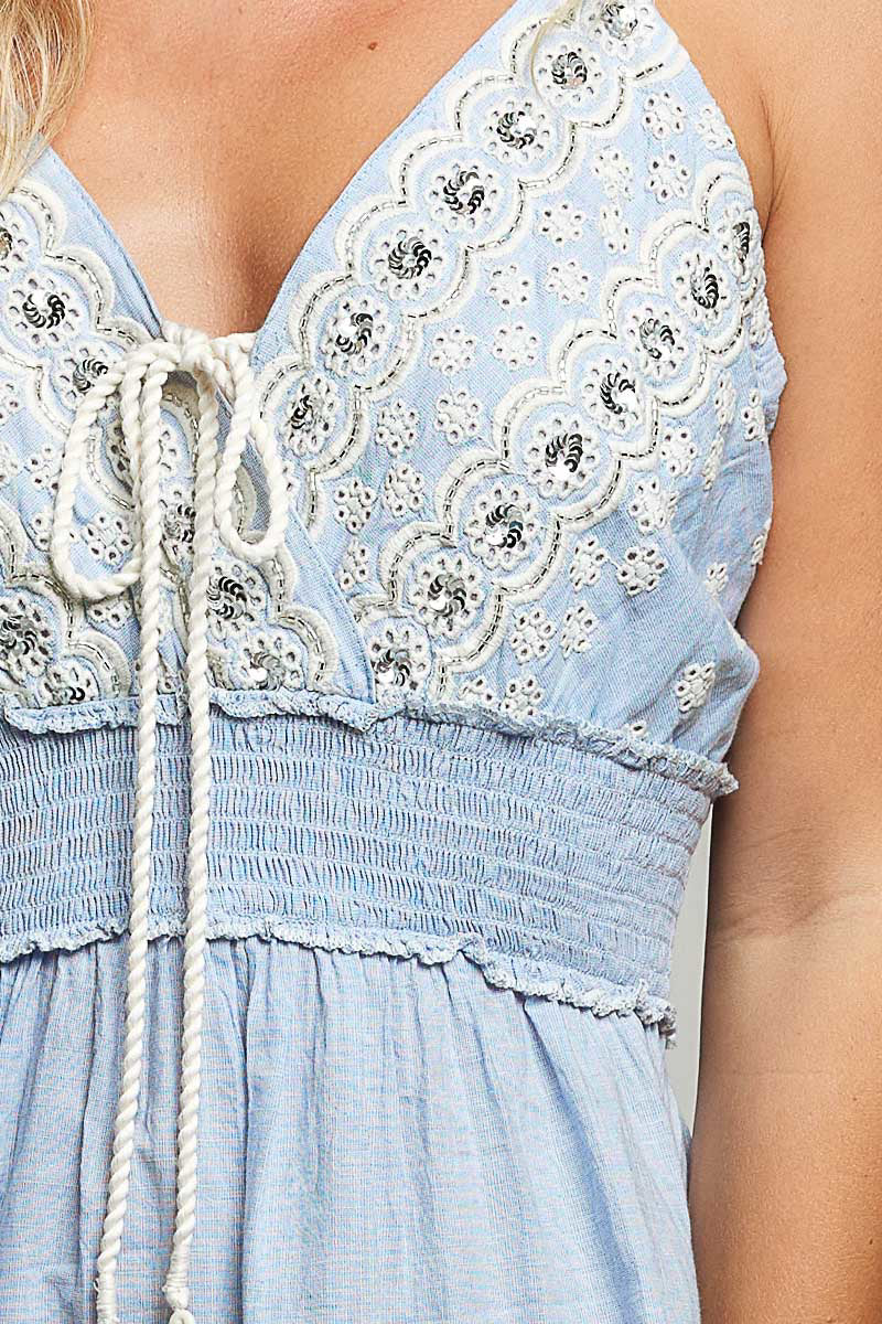 Light blue eyelet embroidered smocked waist mini dress with white rope ties and floral detailing