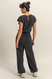 Black cap-sleeve jumpsuit with relaxed fit and round neckline