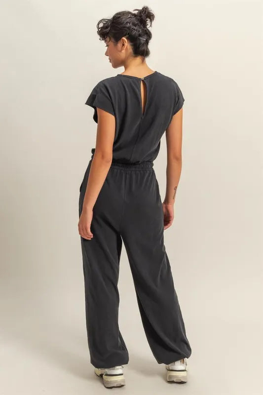 Black cap-sleeve jumpsuit with relaxed fit and round neckline
