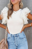 White ribbed blouse with ruffled cap sleeves, fitted round neck, denim pairing