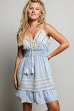 Light blue eyelet embroidered mini dress with smocked waist and tassel tie front