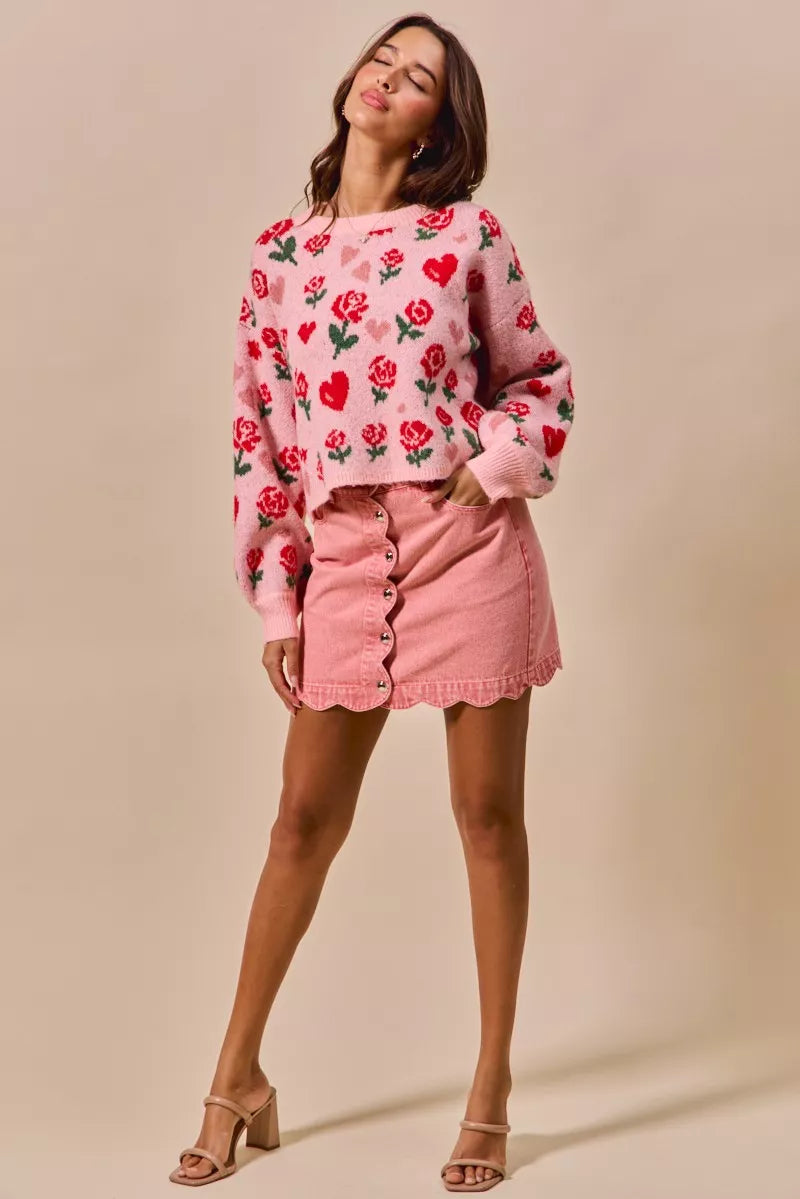 Pink vintage wash denim mini skirt with scalloped edge and button front detail
