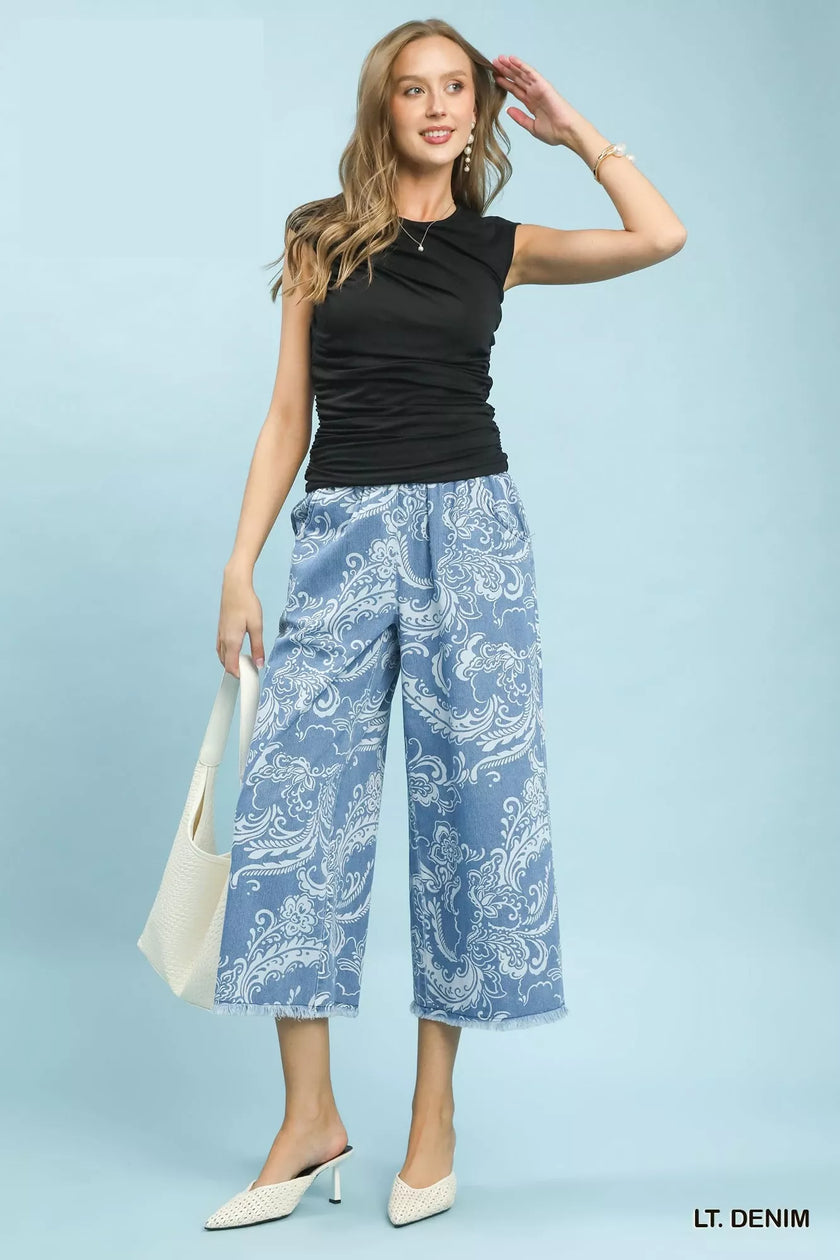 Blue stone wash floral wide leg crop pants with frayed hems and relaxed fit