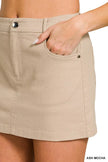 Beige cotton twill mini skirt with side pockets, button closure, and slim fit