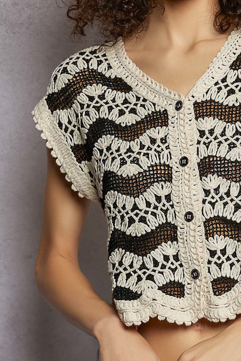 Cream and black crochet button down vest with scalloped edges and open knit texture