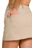 Beige cotton twill mini skirt with a slim fit and front patch pockets