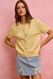 Light wash denim mini skirt with lace ribbon trim and side slit details