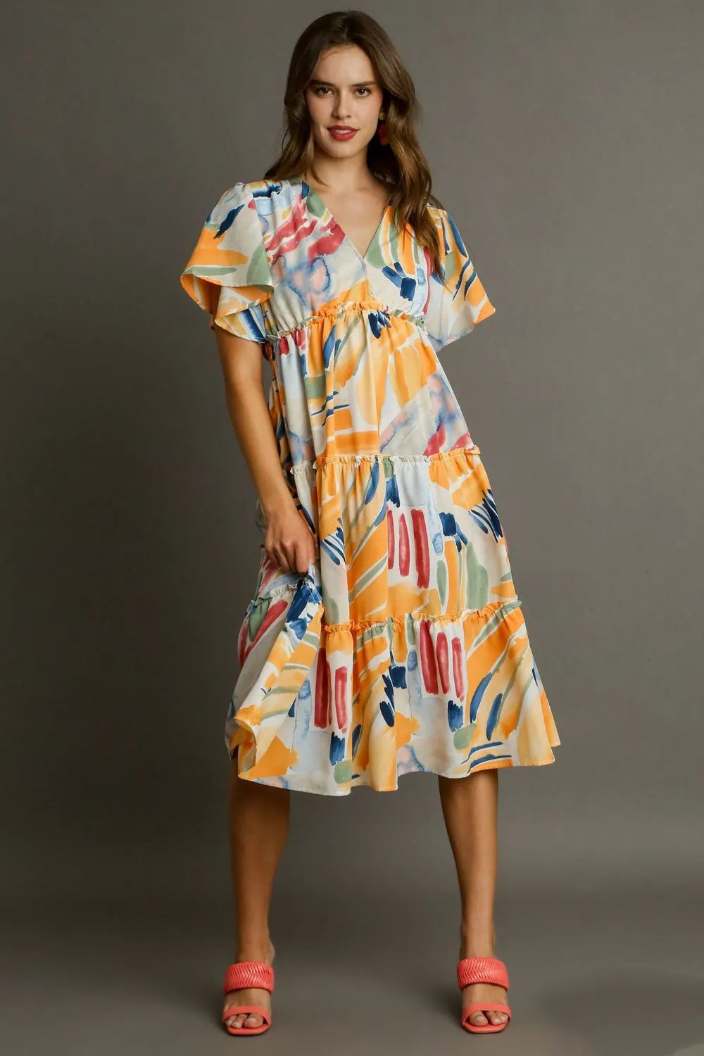 Vibrant abstract print flutter sleeve tiered midi dress with ruffled hem and relaxed fit