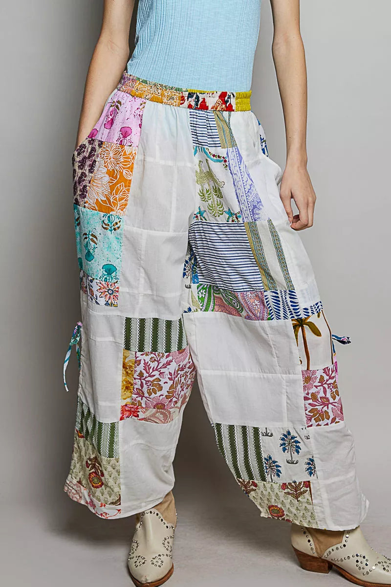 White wide leg patchwork cotton pants with colorful floral prints and side drawstrings