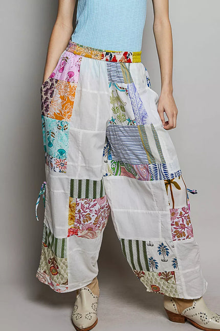 White wide leg patchwork cotton pants with colorful floral prints and side drawstrings