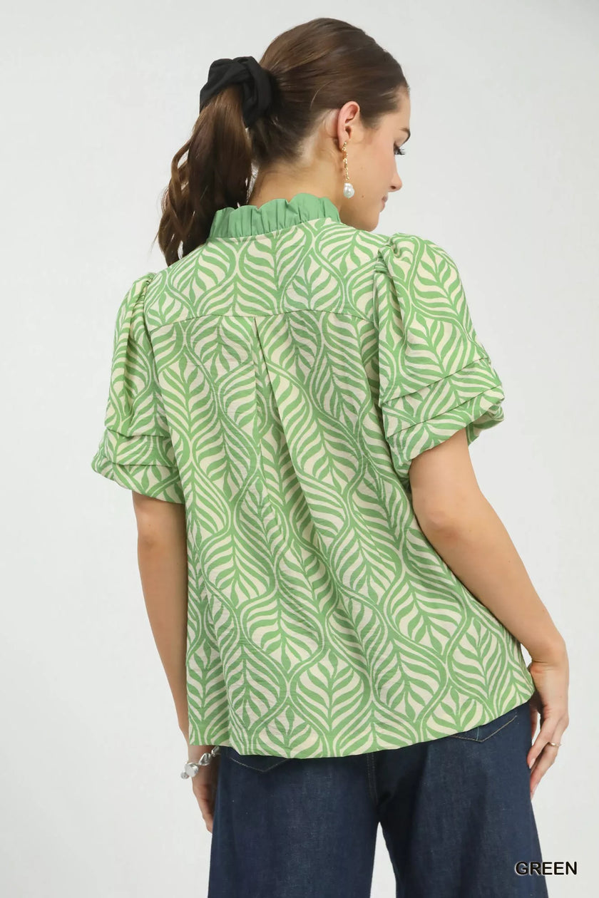 Soft green leaf-print blouse with ruffle neck and puff sleeves