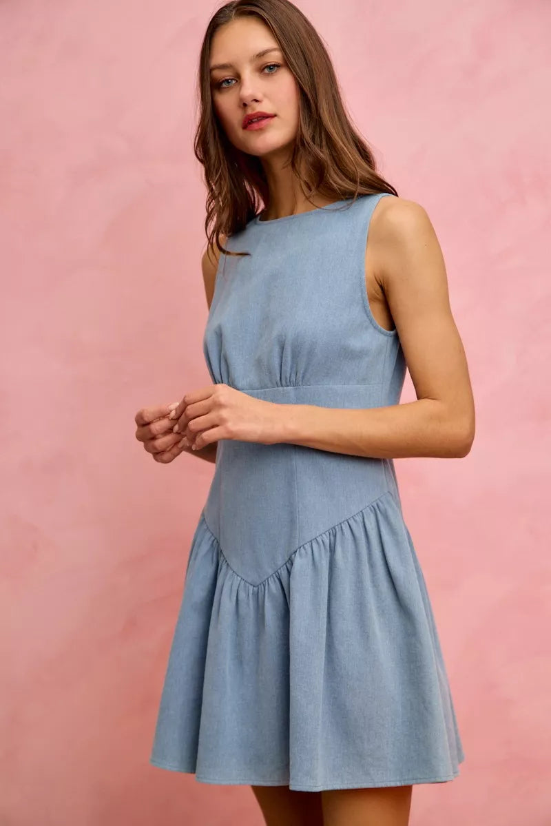Light blue denim sleeveless mini dress with flared skirt and fitted waist.