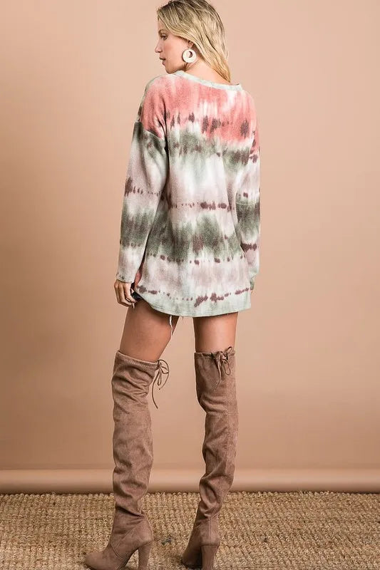 Stretchable tie-dye V-neck top with gradient pink-green swirls, cozy soft knit, paired with high-heeled boots.