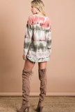 Stretchable tie-dye V-neck top with gradient pink-green swirls, cozy soft knit, paired with high-heeled boots.