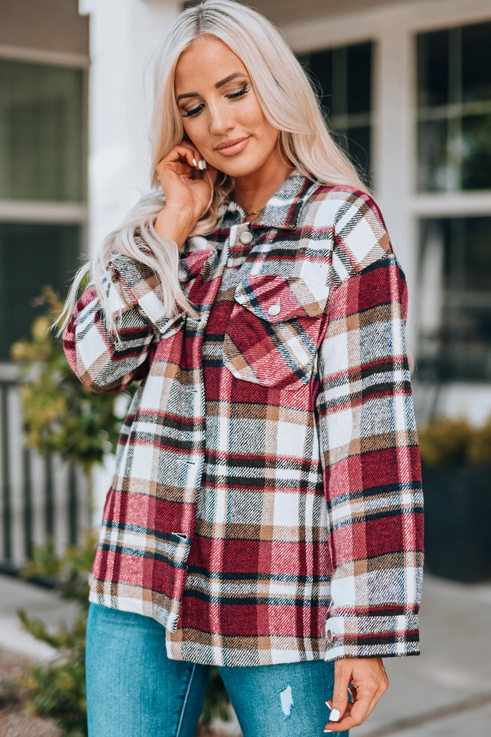 Shirt jacket showing front button detailing and plaid pattern in warm tones