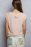 Pink cropped t-shirt with floral patch and lace trim on back