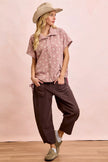 Mocha brown terry pants with relaxed wide-leg silhouette and front detail