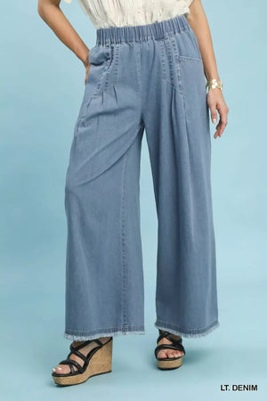 Stone washed light blue wide leg cotton pants with elastic waist and raw hems