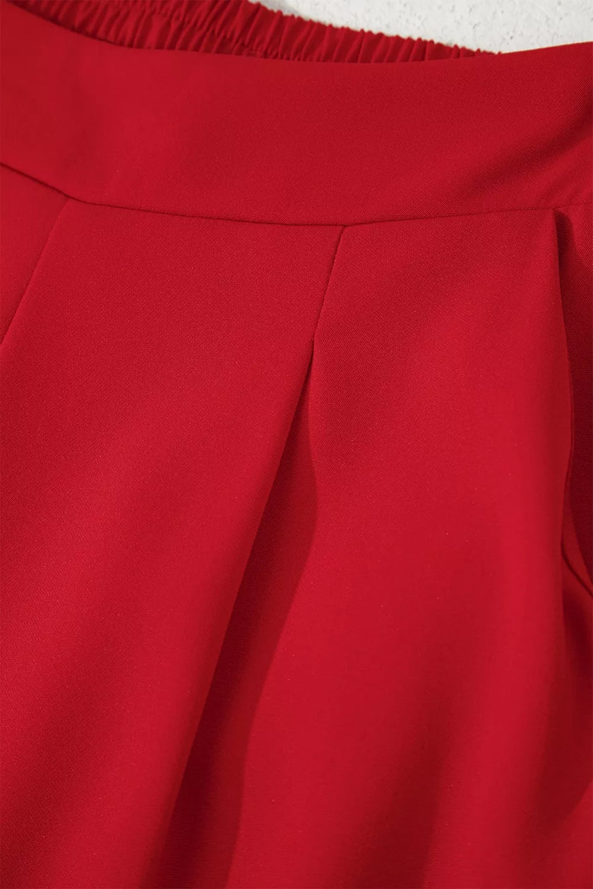 Black pleated straight leg pants folded flat