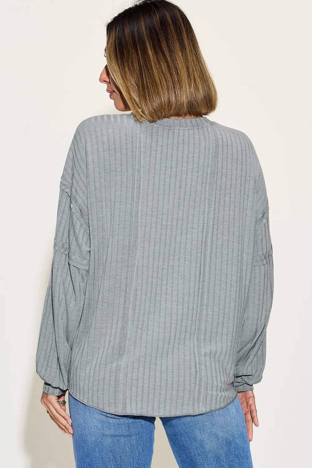 Front view of ribbed long sleeve tshirt over black pants