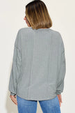Front view of ribbed long sleeve tshirt over black pants