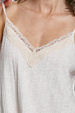 Textured knit cami with delicate lace V-neck trim in soft neutral tones for comfortable fit