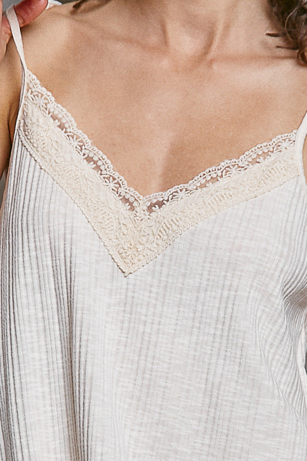 Textured knit cami with delicate lace V-neck trim in soft neutral tones for comfortable fit