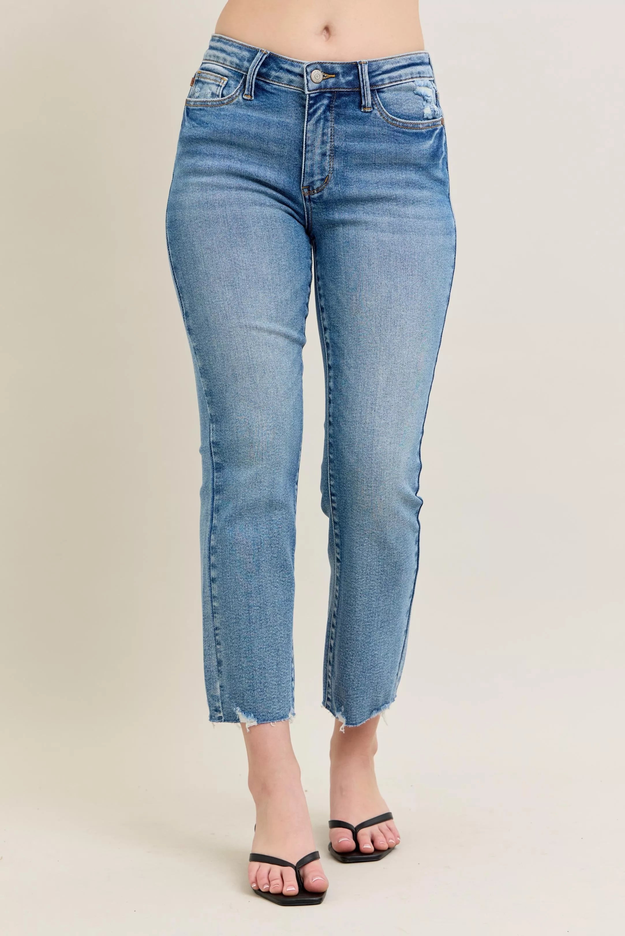 Light blue vintage wash denim jeans with frayed hem and slim fit