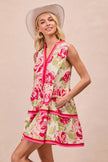 Front view of floral tiered mini dress in coral pink
