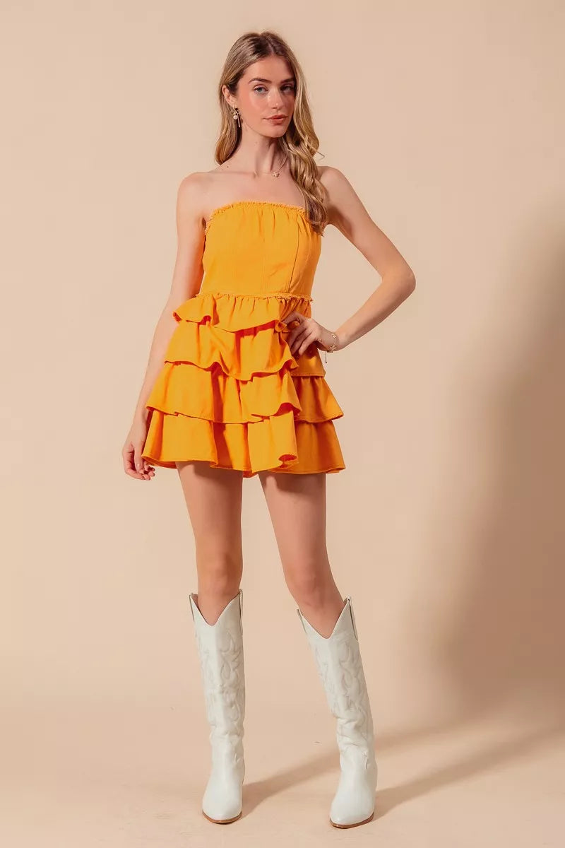 Sunset Gold mini dress showcasing layered ruffle details