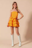 Sunset Gold mini dress showcasing layered ruffle details