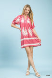 Pink mini dress with white floral print, two-tone border hem and ruffled puff sleeves.