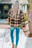 Plaid shirt jacket with buttoned front and breast pockets displayed on hanger