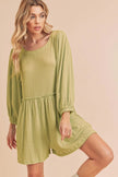 Close-up of chartreuse romper’s frilled long sleeves and elastic waistband