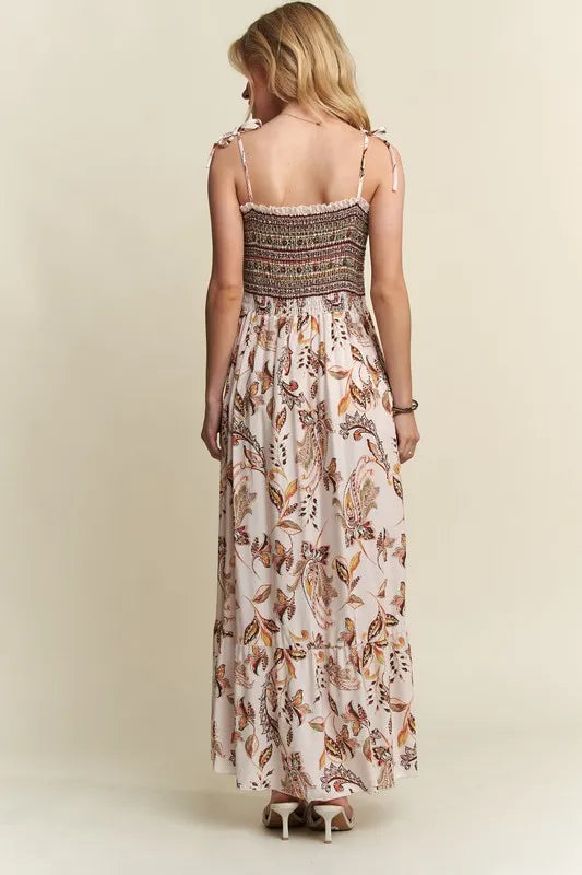 Woman wearing breezy printed rayon dress with smocked waist and tie shoulders