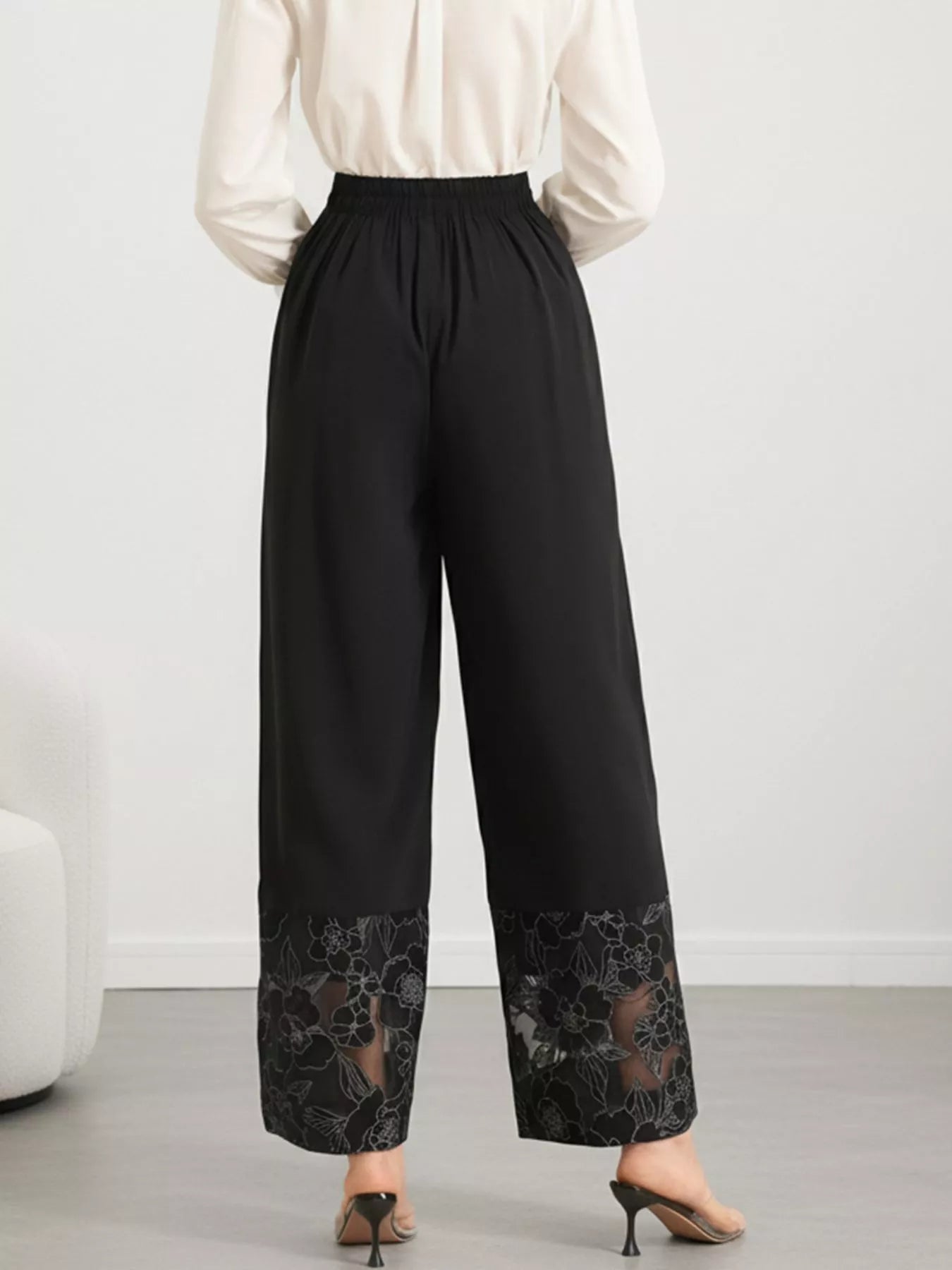 Close-up of lace floral hem on wide leg pants