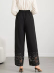 Close-up of lace floral hem on wide leg pants