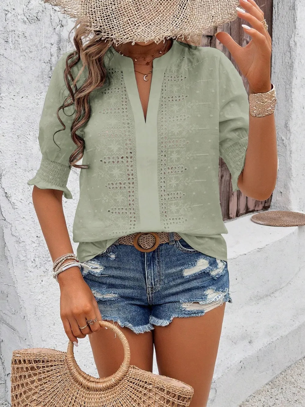 close-up of flounce sleeve edge and feminine eyelet lace pattern on white blouse