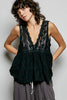 Black lace sleeveless top with deep V-neck, scalloped edges, tiered ruffle hem and sheer texture